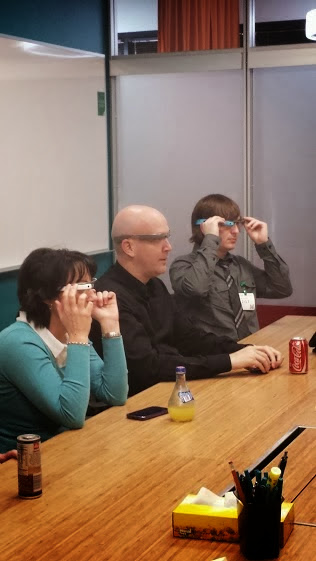 Karine Kugler and Google team members trying on Google Glass in a meeting room at Google headquarters